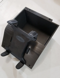 The Can Am Defender Center Dash Insert Tablet Holder is a black plastic rectangular container with an adjustable front-mounted holder. It features two spring-loaded top grips, two support feet at the bottom, and rests on a light surface.