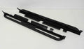 A pair of Mahindra Roxor Rock Sliders by On The Rox, made of black metal with mounting brackets and tubular outer edges, are shown side by side on a light background. They provide protection and a step for vehicle installation.
