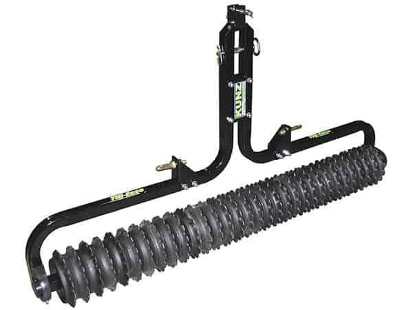 The Cultipacker Till-Ease Model TP3272 is a black metal lawn attachment with a long, ridged cylindrical drum. Its frame displays the RZ Mask brand in green and has mounting points for equipment. It is designed for turf maintenance.