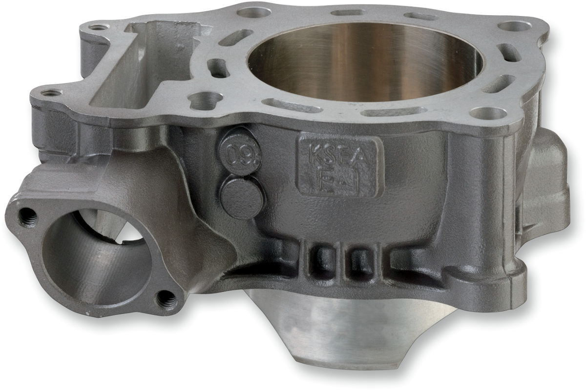 A close-up image of a gray metal engine cylinder block with smooth, machined surfaces, openings for pistons, and various mounting holes. The block features engraved markings and casting details, and its internal cylindrical chamber is clearly visible.