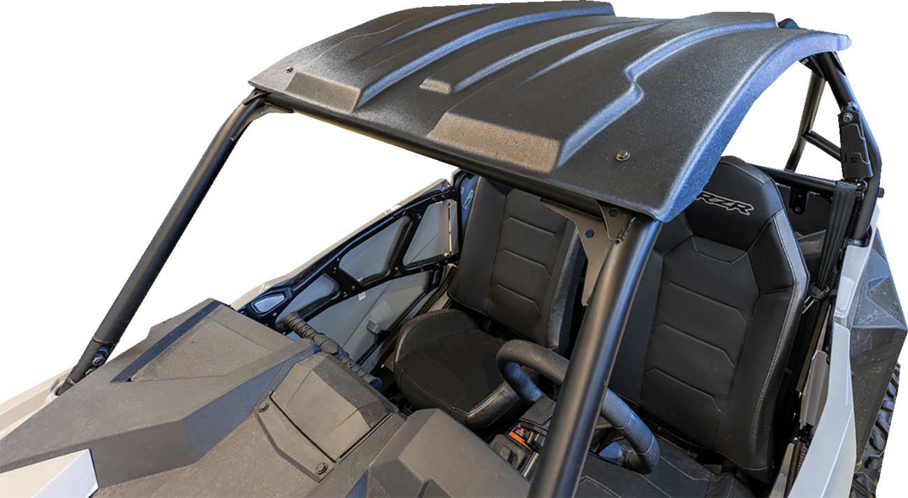 A black, rugged roof attaches to the roll cage of an off-road side-by-side vehicle. The image shows two black bucket seats, a steering wheel, and part of the dashboard, all under the sturdy roof with angular contours. The background is plain white.