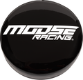 A black round cover with bold white text reading MOOSE RACING in a modern, angular font. The surface is glossy, reflecting light. The background is plain and light-colored, making the cover and text stand out clearly.