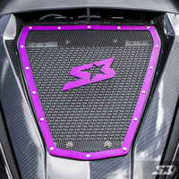 Close-up of the S3 Power Sports 2013+ Can-Am Maverick Vented Hood Insert, featuring a carbon fiber texture, purple-bordered center panel with bolts and mesh, a stylized purple “S” with a star, and a semi-transparent SX logo in the lower-right corner.