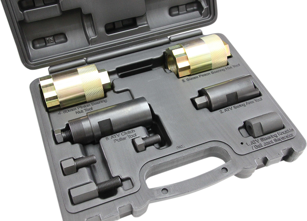 A black plastic carrying case holding four cylindrical metal automotive tools with threaded ends, each in fitted slots. Labels identify them as pullers and installer tools for ATV clutches and bearings. The case is open, showing all components and a handl