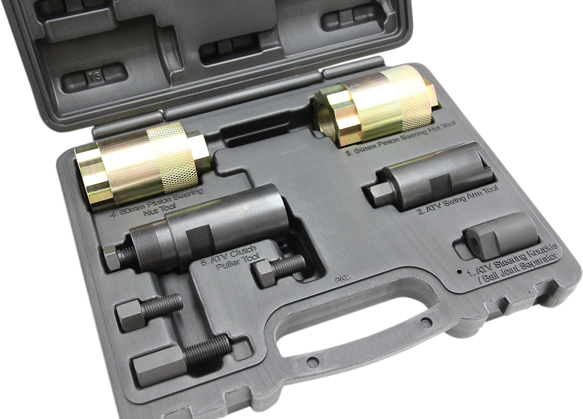 A black plastic carrying case holding four cylindrical metal automotive tools with threaded ends, each in fitted slots. Labels identify them as pullers and installer tools for ATV clutches and bearings. The case is open, showing all components and a handl