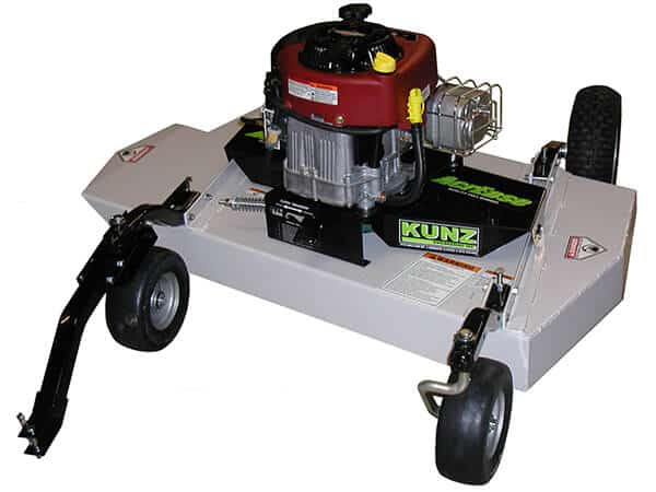 The Finish Cut Mower AcrEase Model H40B is a heavy-duty pull-behind mower with a red and black engine on a rectangular metal deck labeled KUNZ, featuring two large rear wheels, two swiveling front wheels, and a black tow bar for vehicle attachment.