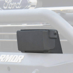 Close-up of a 2017-2020 Ford F-150 Stealth Front Bumper Accessory Adaptive Cruise Control Module in texture black, mounted on the front bumper. A blurred Ford logo and partial ARMOR text are visible in the background.
