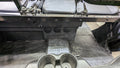 The image shows the rear floor area of a Polaris Ranger XP1000 Crew (2018-2024), featuring a black textured rubber mat, three round vents on the console, two cup holders in front, plus a fabric seat back and metal brackets.