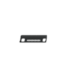A textured black 2018-2020 Ford F-150 Vaquero front non-winch plate rests on a white surface, viewed from the front, with two small rectangular openings on each side and Vaquero labeled in silver at the center.