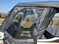A close-up of a Kawasaki Teryx 800 (2-Seater) with black Soft Doors (Open Box Sale), featuring zippered enclosures and clear plastic windows. The steering wheel and dashboard are visible, set against grassy fields and a blue sky.