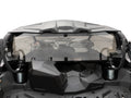 Rear view of a black off-road vehicle fitted with the Can-Am Maverick X3 Tinted Polycarbonate Rear Window. The open cargo bed, roll bars, visible shocks, and interior details like the steering wheel appear against a plain white background.
