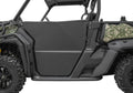 Side view of a Can Am Defender HD5/HD7/HD8/HD9/HD10 with Rival Powersports half doors, matte black step bar, camo rear panels, knobby tires, and open cab, emphasizing utility and durability for tough outdoor terrain.