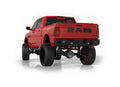 A 2019+ Ram 2500 is shown from the rear with a lifted suspension, oversized off-road tires, and the Identity Rear Bumper featuring Shackles End Pods, dual pod & single row light pods, beauty ring, and hardware kit. Bold black RAM lettering highlights the 