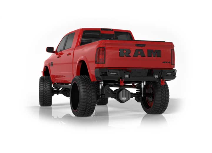 A 2019+ Ram 2500 is shown from the rear with a lifted suspension, oversized off-road tires, and the Identity Rear Bumper featuring Shackles End Pods, dual pod & single row light pods, beauty ring, and hardware kit. Bold black RAM lettering highlights the 