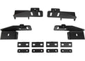 Four black metal brackets with angled edges and slotted holes are arranged in two rows above eight smaller flat rectangular black plates with round holes, all shown on a white background as the 2015+ GMC Canyon Treck Drill-Less Rack Base Mounting Bracket 