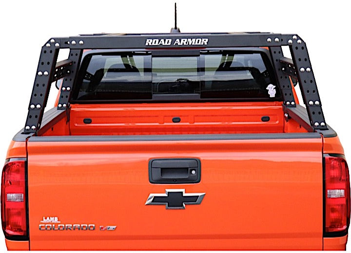 Rear view of an orange Chevy Colorado truck with a 2015+ GMC Canyon Treck 5Ft. Adjustable Bed Rack System (Texture Black) installed. The bed rack has a ROAD ARMOR style, and the bed is empty. Stickers appear on the rear window.