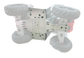 A Polaris Scrambler 850 / XP 1000 Alloy Central Skid Plate is mounted beneath an off-road RC car, protecting the chassis. The car is flipped upside down, revealing large, rugged tires and red suspension components in the background.