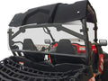 A close-up of a Cf Moto Z-Force 500/800/1000 with a rear vented windshield, black roof, roll cage, two seats with harnesses, steering wheel, red-accented dashboard, and front black cargo net basket.