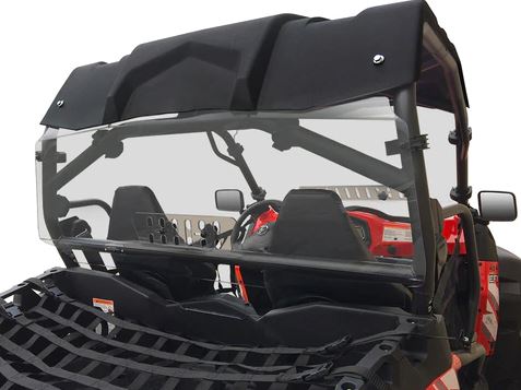 A close-up of a Cf Moto Z-Force 500/800/1000 with a rear vented windshield, black roof, roll cage, two seats with harnesses, steering wheel, red-accented dashboard, and front black cargo net basket.