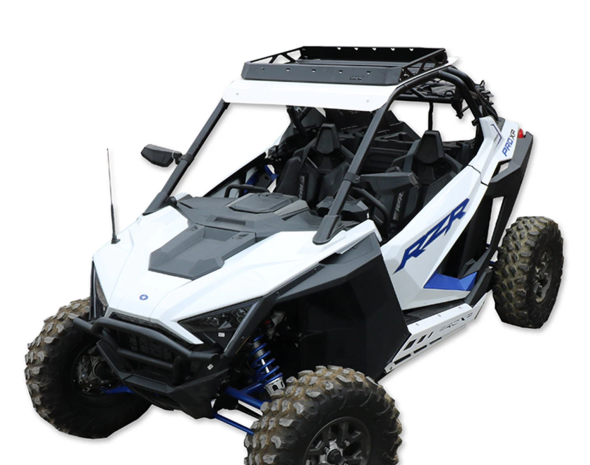 A Roof Rack Kit for the Polaris RZR XP Pro 2 Seater, designed for rough terrain, fits white off-road side-by-sides with muddy tires, open frame, roll cage, black roof rack, blue suspension springs, and RZR decals.