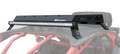 A Roof Rack Kit For Can Am X3 is mounted on the matte black roof of an off-road vehicle with a red tubular roll cage. The sturdy rack sits above the windshield, and a spare tire is visible in the background.