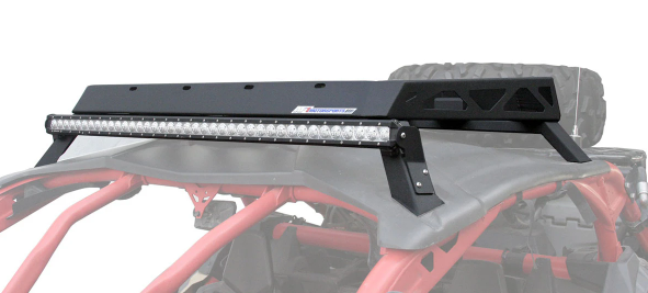 A Roof Rack Kit For Can Am X3 is mounted on the matte black roof of an off-road vehicle with a red tubular roll cage. The sturdy rack sits above the windshield, and a spare tire is visible in the background.
