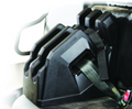 The Seizmik Cab On Seat Gun Holder, shown in black plastic on a light-colored car seat with metal armrest, features slots to organize and secure multiple seatbelt tongues, keeping them untangled and easily accessible.