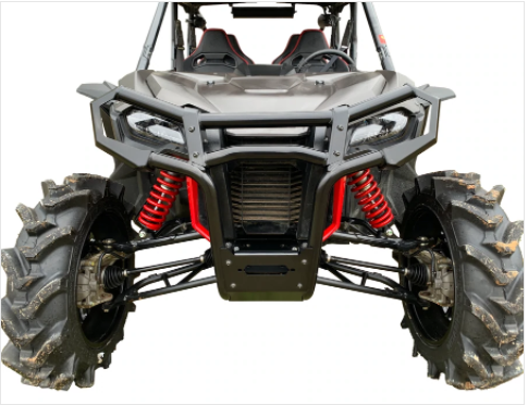 A front view of the Honda Talon with large, mud-covered tires, red suspension springs, and a rugged black Honda Talon Front Bumper. Two bucket seats and harnesses are visible in the open-top cabin against a white background.