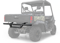 A Can-Am Defender HD5/HD8/HD10 Rear Bumper is mounted on the back of a dark UTV with large off-road tires, shown from the rear. The UTV’s cargo bed and camo side detailing are visible.