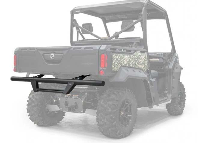 A Can-Am Defender HD5/HD8/HD10 Rear Bumper is mounted on the back of a dark UTV with large off-road tires, shown from the rear. The UTV’s cargo bed and camo side detailing are visible.