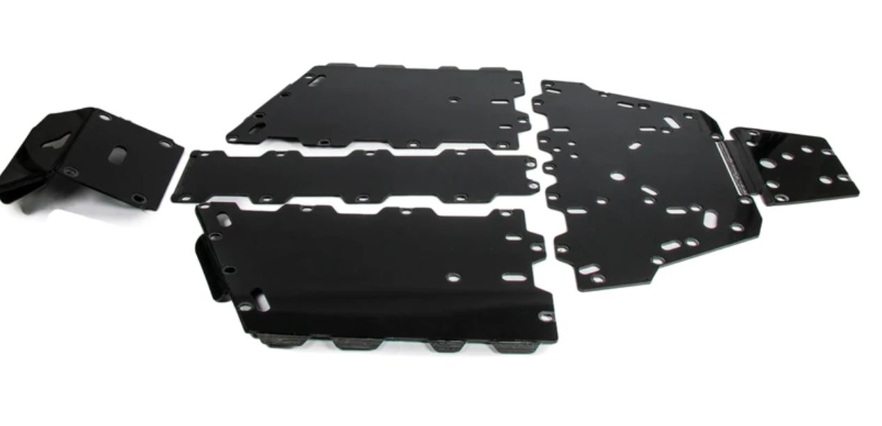 Five black plastic central skid plates for Can Am Defender HD5/HD8/HD10, each with smooth edges, cutouts, and mounting holes, are arranged on a white background, indicating they are protective or structural panels for assembly.