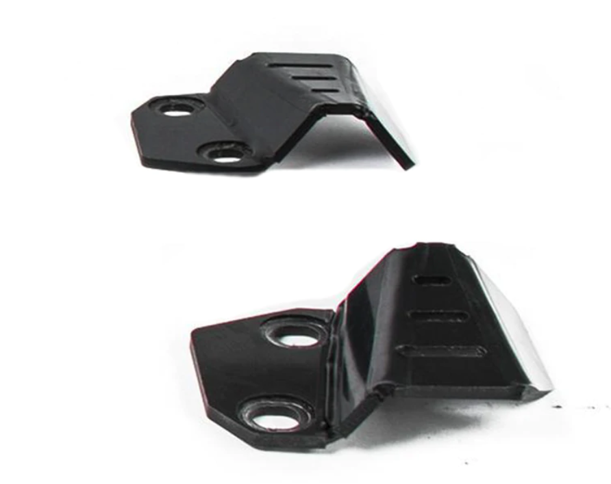 The image shows two black metal brackets for Cf Moto C Force 800 / 800Xc / 1000 Plastic A-Arm Guards. Each has two round mounting holes and three rectangular slots on the raised part, displayed from different angles against a white background.