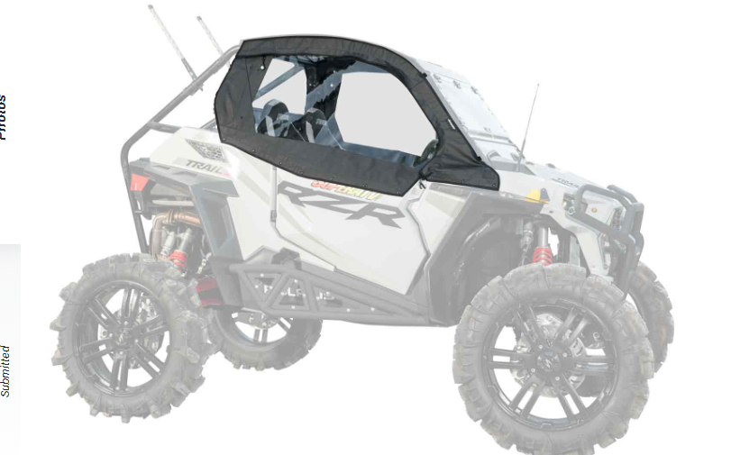 A side view of a Polaris RZR Trail 900 (2021+) with large, rugged tires and a Primal Soft Cab Enclosure Upper. The black-framed enclosure covers the top and sides with clear windows, leaving the lower area open. RZR is labeled on the side.