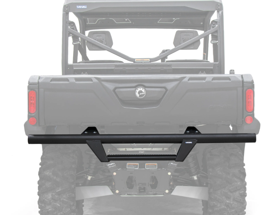 A Can-Am Defender HD5/HD7/HD8/HD9/HD10 Rear Bumper (all years) with angular lines and a center step plate is mounted on a UTV with large knobby tires, showing the rear cargo area, roll cage, and tail lights.