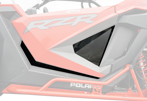 Close-up of Polaris RZR Pro XP-2 Door Inserts with Lower Trim Kit (pair) installed on a red RZR, highlighting the angular side panel design, black window insert, visible white RZR logo, roll cage, and part of the suspension.