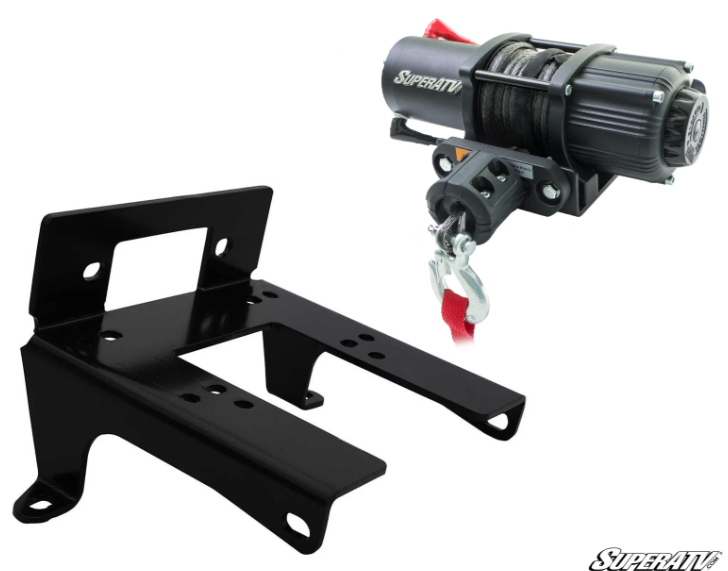 The Canam Commander Winch Mount and 3,500lb Winch set includes a black metal bracket beside a compact electric winch with SuperATV branding, steel cable, red pull strap, and hook. Set against a white background with the logo in the corner.