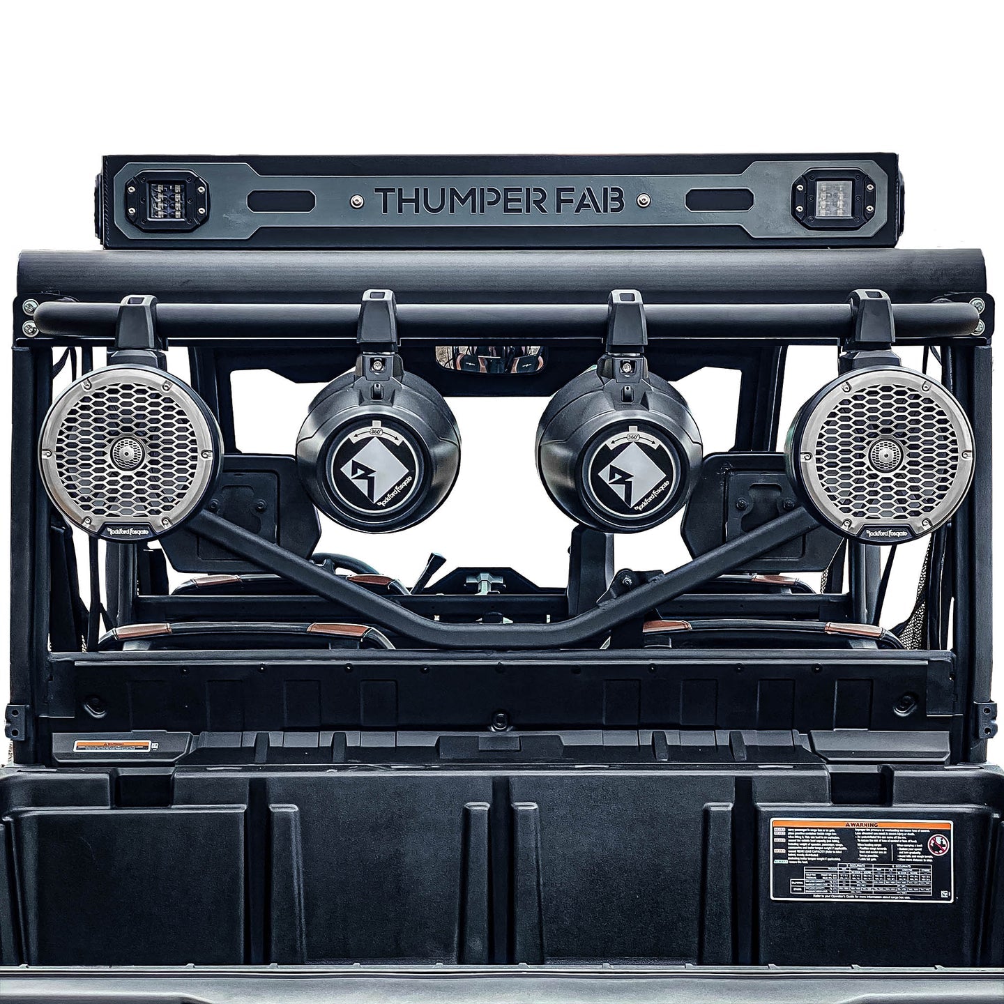 Close-up of a Can Am Defender Wake Tower Speaker Bar Raw mounted on a vehicle roll cage, featuring three Rockford Fosgate speakers and two cylindrical subwoofers. The rugged setup is built for outdoor or off-road adventures.