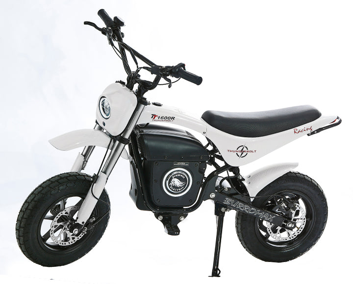 The Burromax Electric Mini Bike TT1600R is a small, white bike with thick black tires, front and rear disc brakes, a black Racing seat, and TT1600R Thunderbolt branding. Its shown on its kickstand against a plain white background.