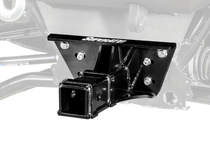 Close-up of a black, heavy-duty metal Polaris Ranger XP 1000 Front 2 Receiver Hitch mounted to a vehicles front, secured with multiple bolts. The SUPERATV logo is visible on the top edge. A faded background highlights the hitch.