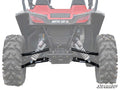 Rear view of a red and black vehicle with ARCTIC CAT in white on the back, featuring large tires, visible suspension springs, and black Arctic Cat Wildcat Sport High Clearance Rear A-Arms.