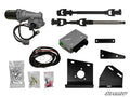 The Arctic Cat Wildcat Sport Power Steering Kit is displayed on a white background with a motor, control box, wiring harness, steel shafts, mounting brackets, hardware bolts, and electrical connectors—all components clearly organized and visible.