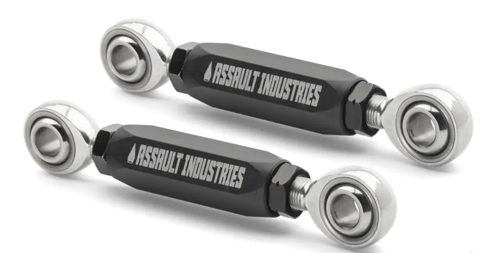 Two black and silver Front Heavy Duty Sway Bar End Links with ASSAULT INDUSTRIES logos lie parallel on a white background. Each has a hexagonal center and polished metal rod ends with mounting holes.