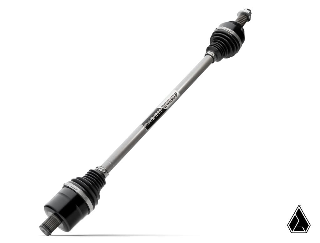 The Assault Industries MAS-223 Phoenix Axle for Polaris RZR XP Turbo S is shown diagonally on a white background, featuring black rubber boots on each end, a metal center shaft, and a small black geometric logo in the bottom right corner.