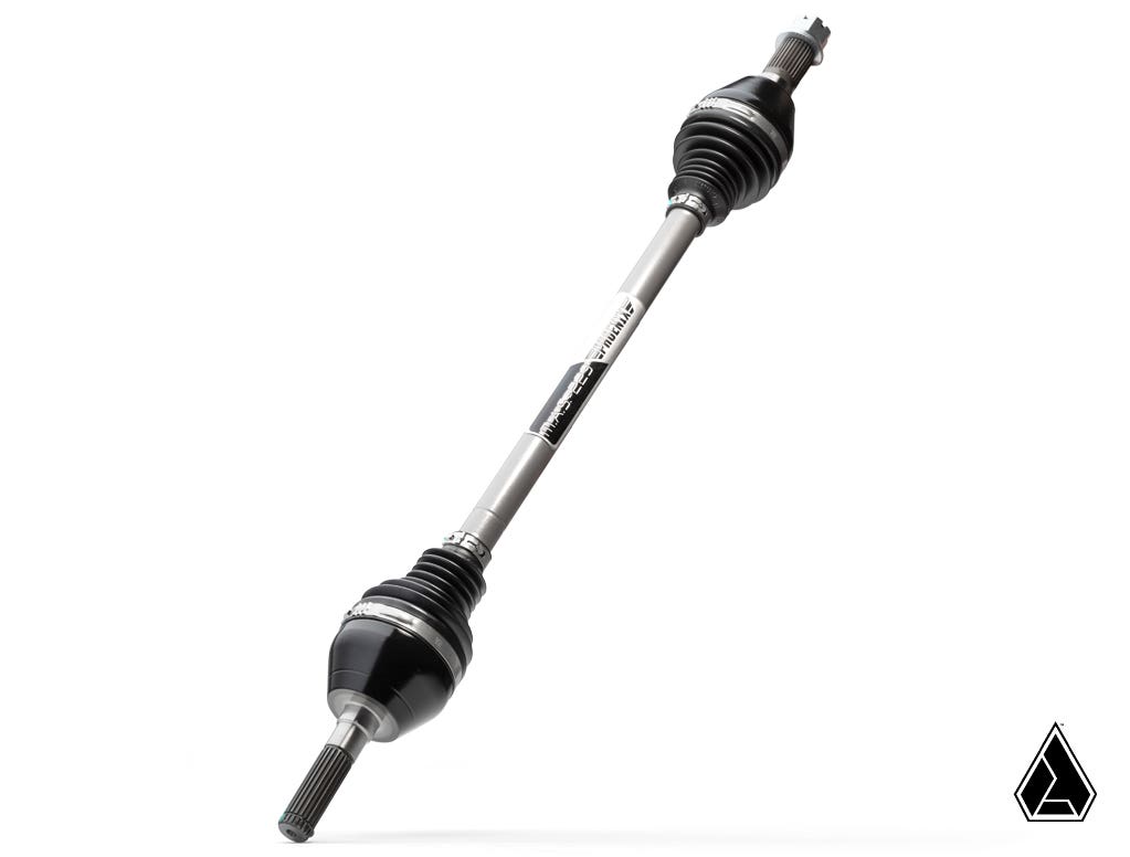 The Assault Industries MAS-223 Phoenix Axle for Can-Am Maverick X3 is shown diagonally on a white background, featuring black rubber boots on both ends, ridged splines for fitting, and a small geometric logo in the bottom right corner.
