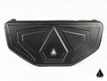 The Assault Industries RUXAK Deck Pak for Recon Rack (Can-Am Maverick X3) is a black, textured hard-shell case with an angular geometric pattern and a small triangular logo centered on the front. The background is white with a matching logo at the bottom 