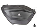 The Assault Industries Polaris RZR Pro R RUXAK Door Paks feature a hard-shell, black design with carbon fiber texture, a small geometric logo, reinforced corners, top zipper, and secure attachment points for your vehicle.