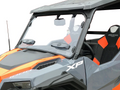 A close-up of a Polaris General Full Size Scratch Resistant Windshield With Sliding Vent (2016+) installed on a gray and orange off-road vehicle, highlighting the windshield, side mirror, XP and General logos, seat, and front driver’s side.