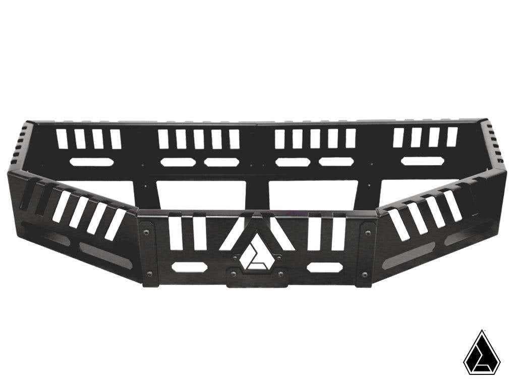 The Assault Industries Recon Rack for Can Am Maverick X3 features angular black metal construction with geometric cutouts and reinforcement bars. A triangular logo is centered on the front, set against a plain white background with a small black logo bott
