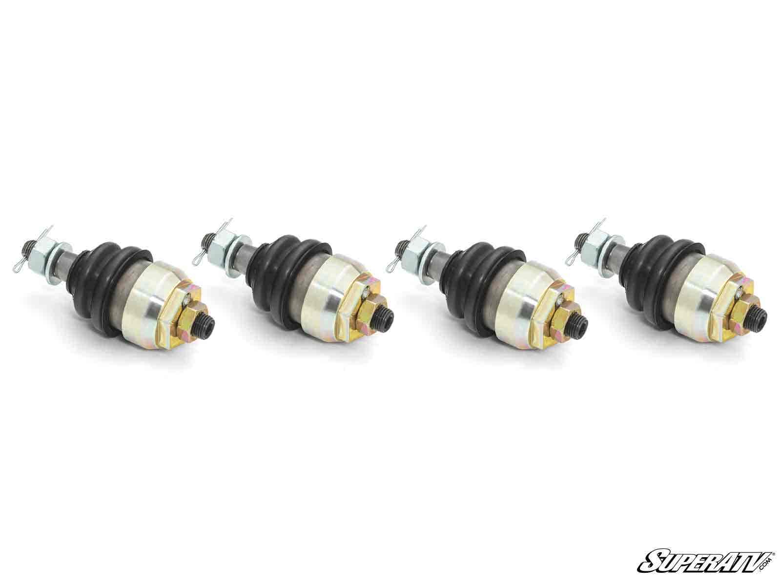 Four Kawasaki Teryx Keller Ball Joints with gold and silver components, black rubber boots, and threaded studs are arranged in a row on a white background. Each features visible nuts, with the SuperATV logo in the lower right corner.