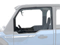 A partial side view of a Polaris XPEDITION with its Light Tint Poly Upper Front Doors (Pair) removed, revealing the steering wheel, two seats, and interior. The vehicle appears light blue on a white background with gray top and rear sections visible.